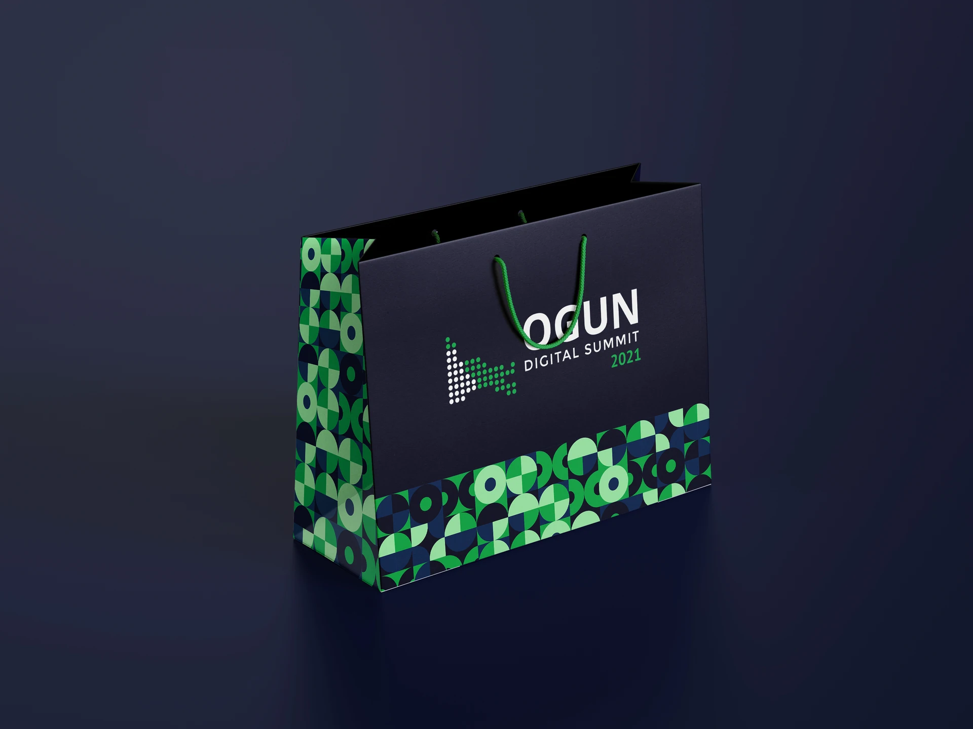 Navy ODS gift bag with green handles, the summit logo and a patterned base