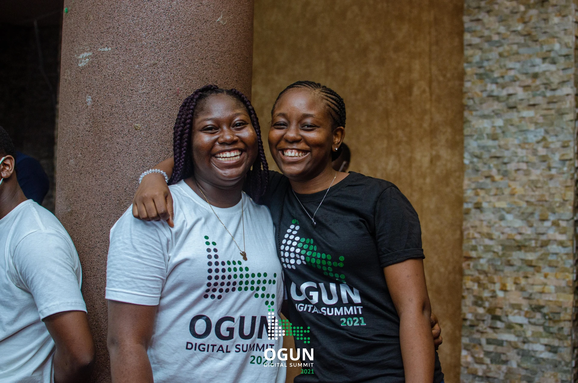 Two event attendees wearing light and dark Ogun Digital Summit 2021 T-shirts